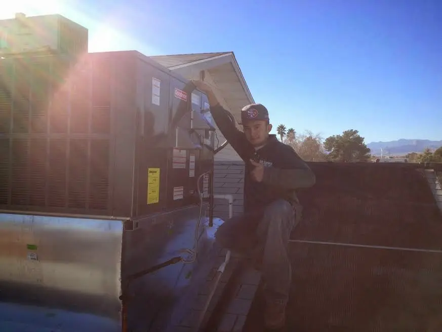 HVAC technician performing Boiler Repair on a rooftop unit in West View